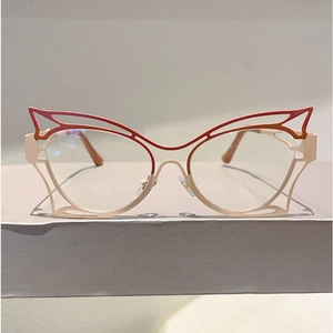 Detail of red and pink butterfly cat eye frames with hollow geometric metal design