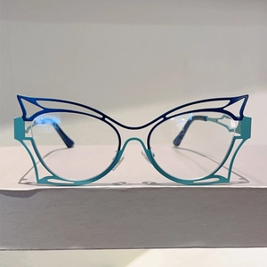 Close-up of cat-eye butterfly frame glasses featuring blue to green gradient hollow design