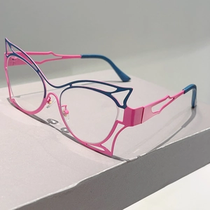 Detail of pink and blue cutout cat-eye metal frame glasses on a minimalist podium