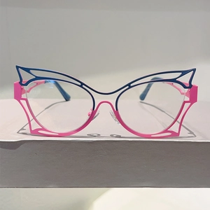 Detailed view of hollowed butterfly frames in dual-tone deep blue and magenta metal finish