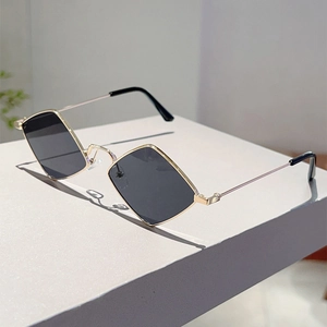 Detailed view of irregular diamond-shaped dark grey lenses with elegant gold metal frame