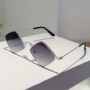 Detail view of silver metal diamond frame sunglasses with gradient grey lenses