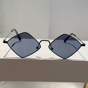 Detail of trendy irregular rhombus sunglasses with slim black metal frame and dark lenses