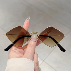 Retro small frame geometric sunglasses with gold metal kite-shaped rims and brown gradient lenses
