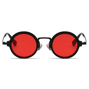 Detail of vintage steampunk sunglasses featuring matte black round frames and red lenses