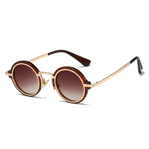 Detail of retro steampunk sunglasses with gold metal frame and brown gradient lenses