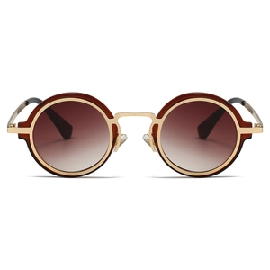 Detail of round steampunk sunglasses featuring brown gradient lenses and gold metal bridge