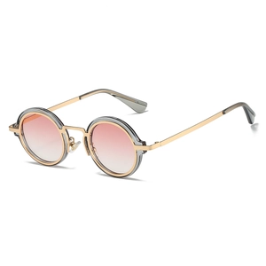 Detail view of steampunk round sunglasses with gold frames and gradient pink lenses