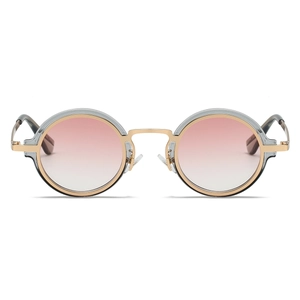 Detail of round steampunk sunglasses with gold metal frame and pink gradient lenses