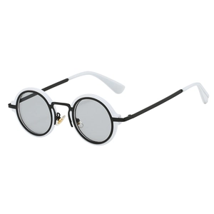 Detail of retro round steampunk sunglasses with black and white contrast frame design