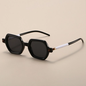 Detail of square sunglasses with black and white color-block temples and metal hinge