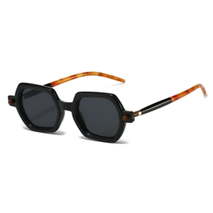 Retro black hexagonal sunglasses with tortoiseshell temples and gold metal accents