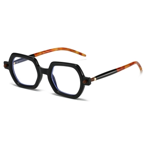 Detail view of bold black square frame with tortoise shell temples for retro eyewear