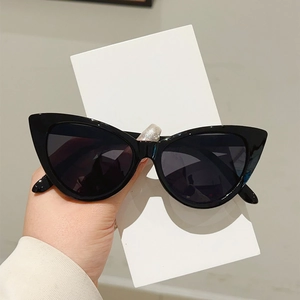 Retro black cat-eye sunglasses with thick glossy frames and dark tinted fashion lenses