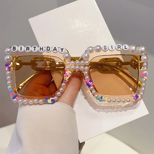 Detail of square birthday sunglasses with white pearls and BIRTHDAY GIRL lettering