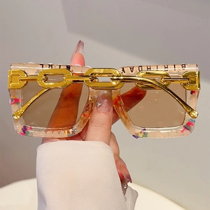 Detail of square glasses with gold chain, colorful sequins and Birthday Girl text