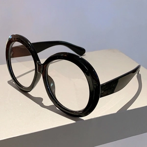 Detail of oversized retro black round frames with clear blue light blocking lenses