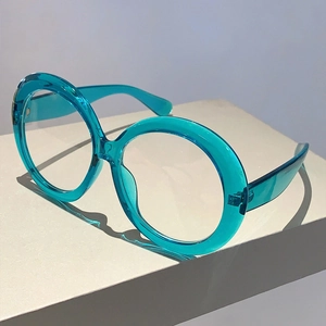 Detail of oversized blue transparent round frames made of high-quality acetate material