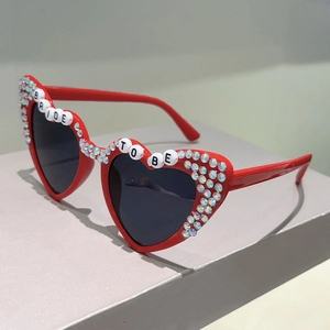 Detail of red heart sunglasses with BRIDE TO BE lettering and sparkling rhinestones
