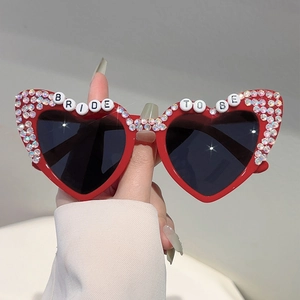 Red heart-shaped sunglasses with colorful rhinestones and BRIDE TO BE lettering