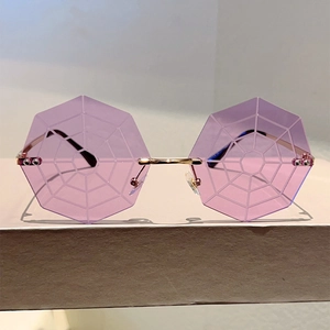 Detail of purple spider web pattern octagonal lenses on gold metal frame sunglasses