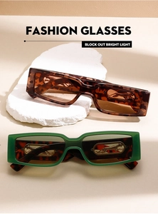 Detailed view of leopard head gold ornaments on rectangular vintage sunglasses frames
