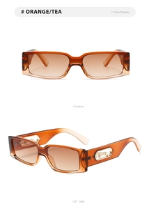 Detail of orange square sunglasses with golden leopard metal cutout on temples