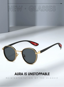 Macro detail of retro round sunglasses with gold metal bridge and red temple tips