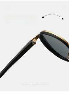 Detail of durable gold metal hinge on round frame sunglasses with a black and gold finish