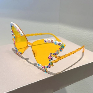 Detail of candy-colored beads and Birthday Queen lettering on party sunglasses