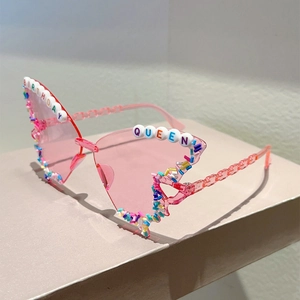 Detail of pink butterfly party glasses with Birthday Queen beads and colorful sprinkles