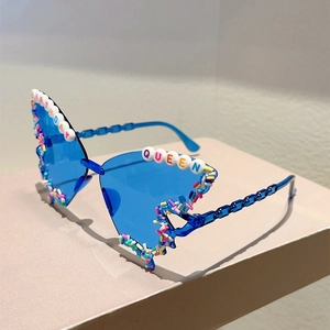 Detail of blue butterfly sunglasses featuring Birthday Queen beads and rainbow sprinkles