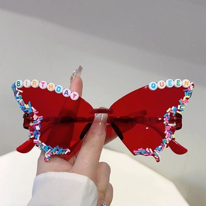 Butterfly wing party sunglasses with Birthday Queen beads and colorful candy accents