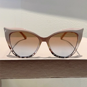 Detail of pink cat eye sunglasses with tortoise pattern and gradient lenses