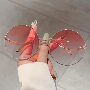 Fashionable round metal sunglasses with pink gradient lenses and slim gold frame