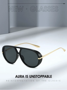 Detail of pilot sunglasses with bold black frames and slim golden metal temples