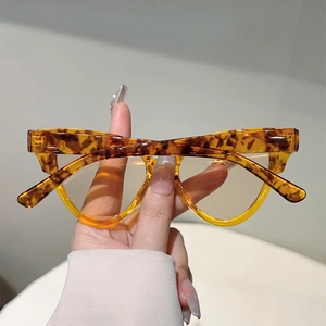 Detailed view of tortoiseshell frames with yellow lenses and vintage leopard patterns