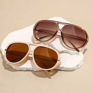 Classic aviator sunglasses with oversized frames and metallic bridge in beige and brown