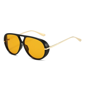 Classic aviator sunglasses with thick black frames and yellow lenses at 45-degree angle