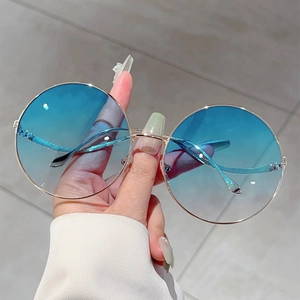 Fashionable round gold metal frame sunglasses with blue gradient lenses for a stylish look