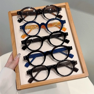 Detailed close-up of retro round blue light blocking glasses in various assorted colors