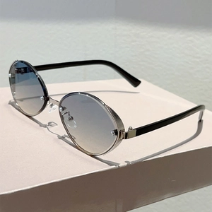 Detail of oval rimless sunglasses with blue-yellow gradient lenses and silver metal bridge