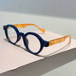 Detailed 45-degree angle of retro round eyeglasses with blue frame and tortoise temples