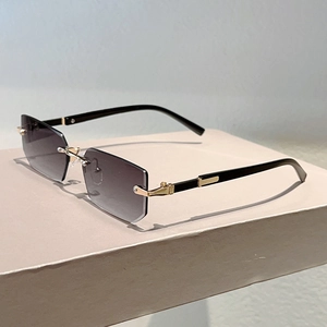 Detailed side view of rimless rectangle sunglasses with gradient lenses and gold hinges