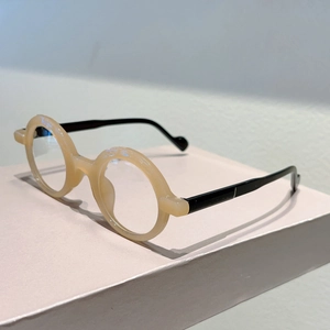 Detail view of retro round translucent yellow frames with slim black temples