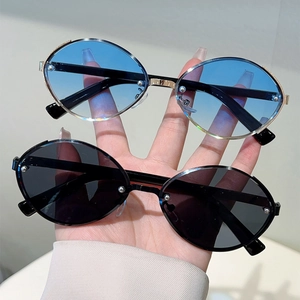 Modern oval sunglasses with metal frames and gradient lenses in a stylish punk design