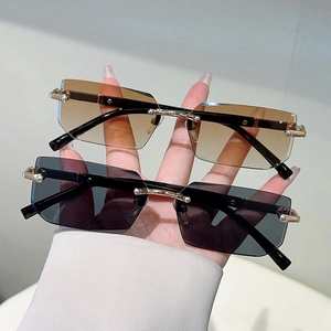Fashionable rimless rectangular sunglasses with gold metal frame in brown and grey tint