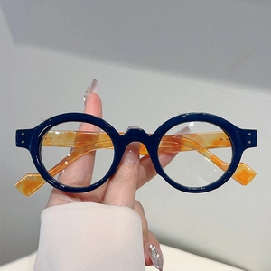 Stylish round blue frame glasses with orange tortoise temples and metal rivet accents