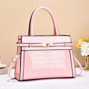 Pink patent leather handbag featuring crocodile pattern texture and gold rotary lock detail