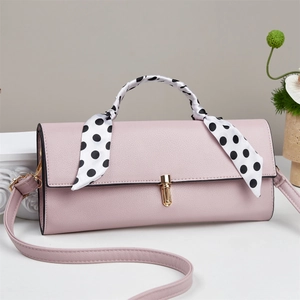 Pink PU leather handbag detail with polka dot scarf-wrapped handle and gold twist lock